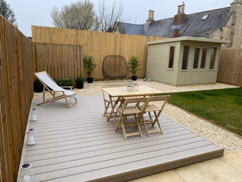 Light composite decking installed as a dining terrace in a completed Bristol garden