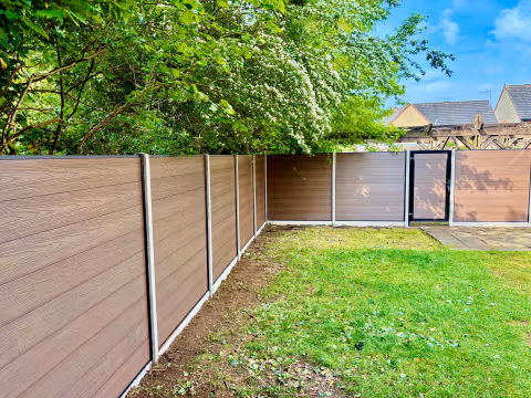 Woodgrain composite fencing and matching gate installed in a Bristol garden