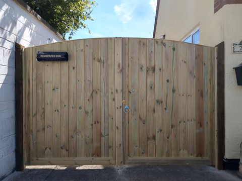 Pair of made-to-measure curved timber driveway gates in Bristol