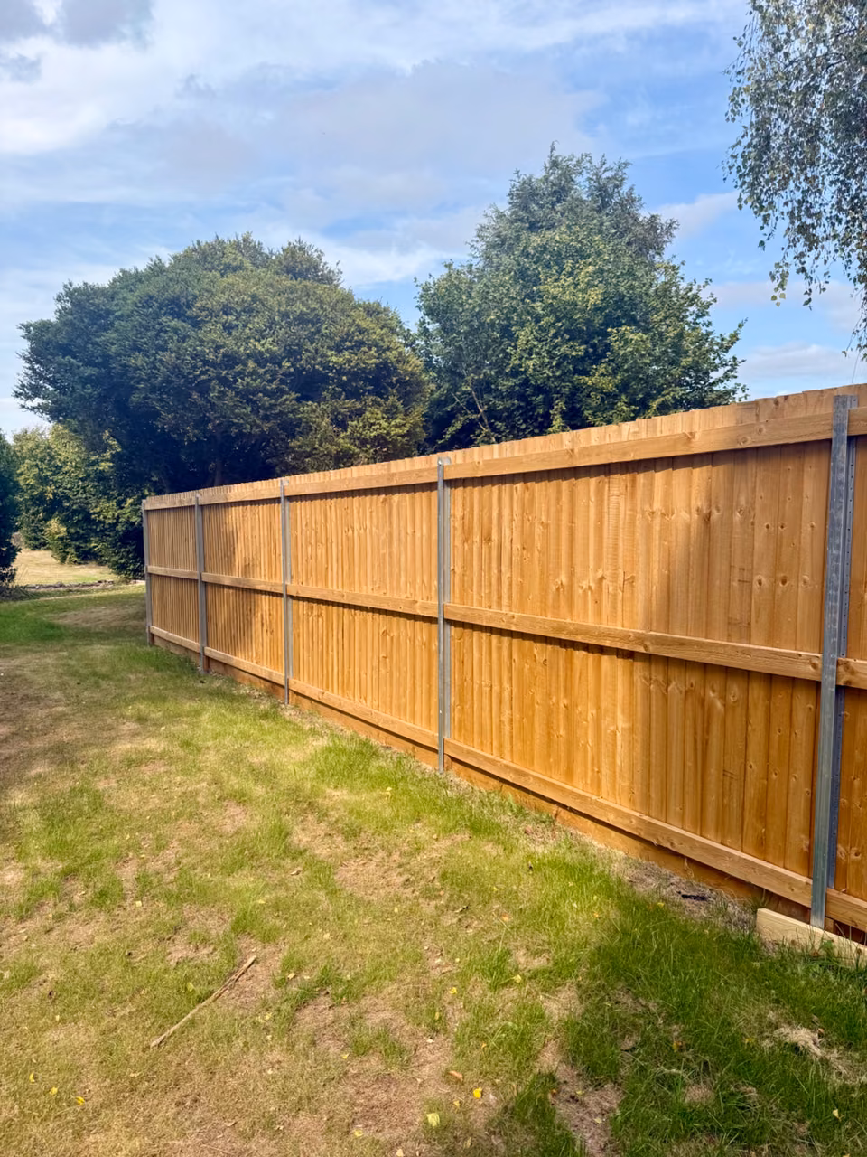 Straight feather-edge fencing installed between durable posts