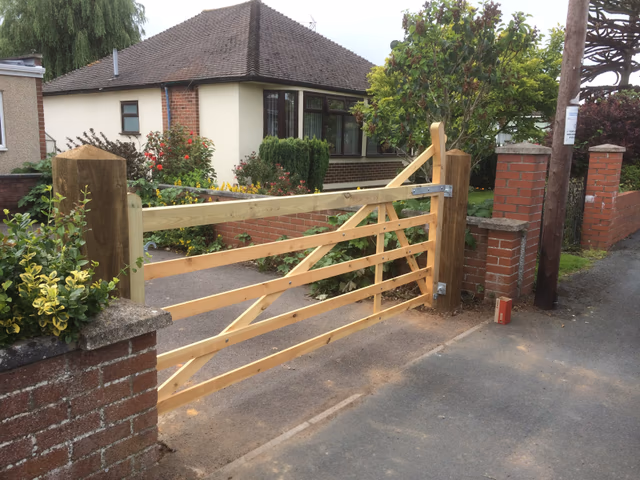 Traditional timber field gate fitted between substantial timber posts