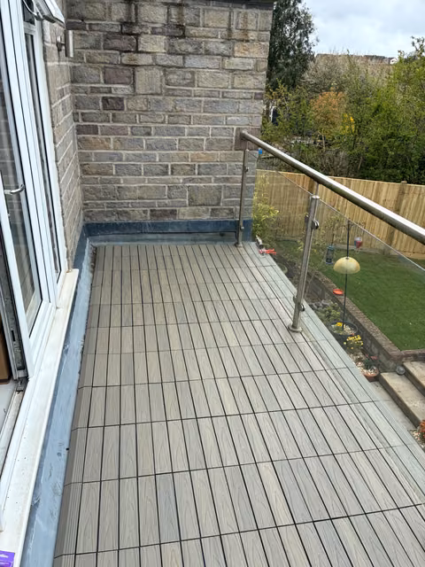 Interlocking NeoTimber composite deck tiles fitted over a solid balcony in Longwell Green