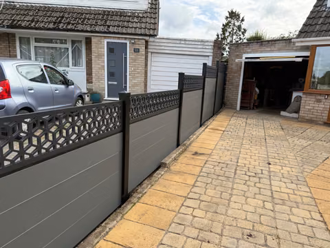 Wide view of the Aspen composite slat and cube-trellis front boundary in Stockwood