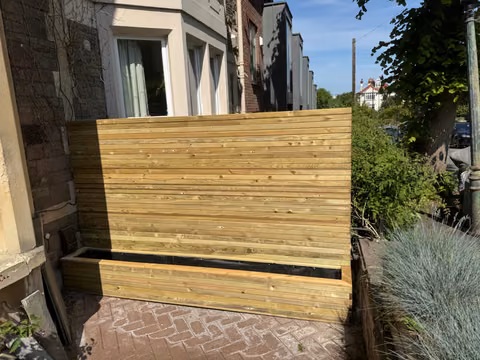Freestanding timber planter with contemporary slatted privacy screening at a Totterdown home